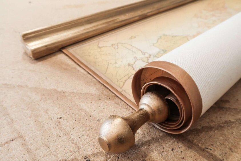 Chic map of the world with golden edges rolled-up